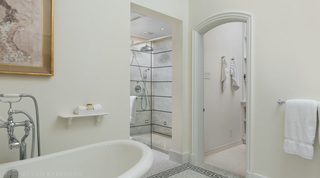 Marble shower seen past the bath, an arched doorway to the linen alcove beyond, Crystal Springs, Barbados