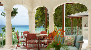 Coral stone dining loggia with terracotta rattan chairs and sea views, Crystal Springs villa, Barbados