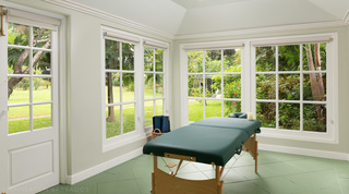 Massage room with windows to the garden on three sides at Crystal Springs, St. James, Barbados