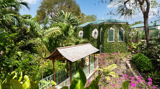 Creeper-clad garden building above the timber-shingled bridge over the gully, Crystal Springs villa, Barbados