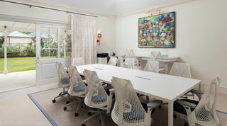 Meeting room with a white table and mesh-back chairs opening to the lawn, Crystal Springs, The Garden, Barbados