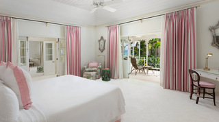Crystal Springs bedroom in pink and white stripes opening to a sea-view verandah, Barbados