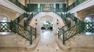 Grand double staircase with green trellis balustrades and stone floor at Four Winds holiday villa, Barbados