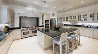 Four Winds kitchen in Barbados, cream cabinetry with a dark granite island and a range cooker