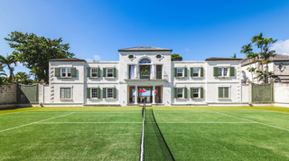 Tennis court before the symmetrical Palladian facade of Four Winds, Barbados