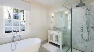 Bathroom with a freestanding tub and marble walk-in shower at Four Winds in St. Peter, Barbados