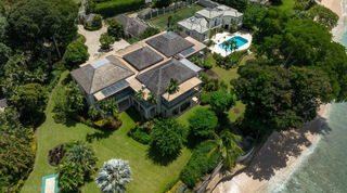 Aerial of Four Winds in Barbados with its beach-edge lawns, a shuffleboard court, the pool and tennis court