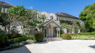 Palladian-style entrance facade and coral-stone driveway at Four Winds, a luxury villa rental in St. Peter, Barbados