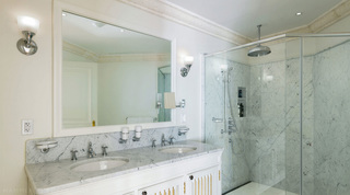 Double-vanity bathroom with twin marble basins and a marble shower at Four Winds, Barbados