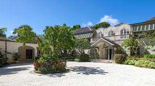 Coral-stone courtyard and arched carport beneath a shade tree, Four Winds villa in Barbados