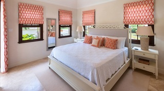 Double bedroom with coral ikat blinds and twin nightstands at Garden Wall 13, Barbados