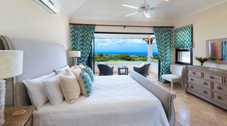 Master bedroom opening to a balcony over the golf course at Garden Wall 13 villa, Barbados