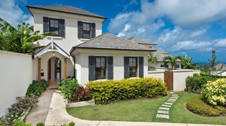 Front entrance and shuttered facade of Garden Wall 13, an Apes Hill holiday villa in Barbados