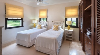 Twin bedroom with golf-course view windows and dark wood wardrobe at Garden Wall 13, Barbados