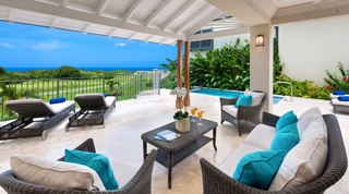 Covered lounge terrace with rattan seating above the golf course at Garden Wall 13, Barbados