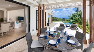 Covered terrace dining set with views over the golf course at Garden Wall 13, Barbados villa rental