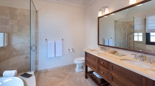 Ensuite bathroom with walk-in shower and wooden double vanity at Garden Wall 13 villa, Barbados