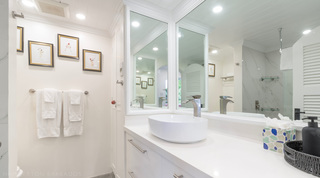 Glitter Bay 204 Sea Men's Inn bathroom vanity with a vessel basin, framed prints and hanging towels, Barbados