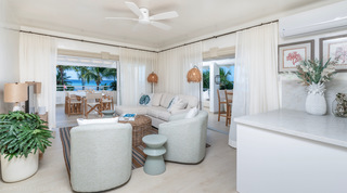 Open-plan living room with swivel chairs opening to the sea-view terrace, Glitter Bay 301 – The Lighthouse, Barbados