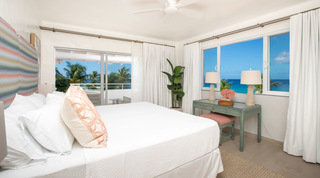 King bedroom with the turquoise sea framed through a window, Glitter Bay 301 – The Lighthouse, Glitter Bay, Barbados