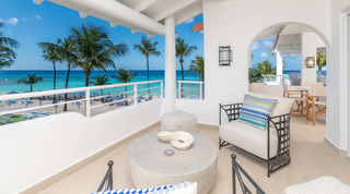 Covered terrace seating overlooking the beach and sea at Glitter Bay 301 – The Lighthouse, beach apartment in Barbados