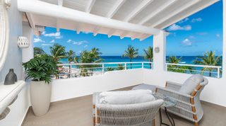 Glitter Bay 301 – The Lighthouse covered terrace with woven armchairs, palms and sea beyond, Barbados