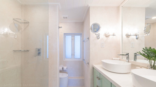 Bathroom with walk-in glass shower and twin vessel basins at Glitter Bay 302 Bikini Bottom, Barbados