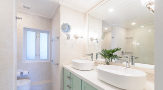 Twin vessel basins and large mirror above a green vanity, Glitter Bay 302 Bikini Bottom apartment, Barbados