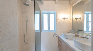 Shower room in coral stone with twin vessel basins, Glitter Bay 302 – Bikini Top apartment, Barbados