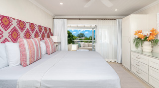 Pink ikat headboard and terrace doors in a bedroom at Glitter Bay 302 – Bikini Top, Barbados