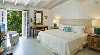 Glitter Bay 308 bedroom, white-dressed bed and French doors opening to a leafy balcony, Barbados
