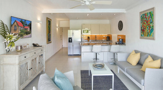 Living room and granite breakfast bar at Glitter Bay 308, an apartment in Barbados with botanical artwork