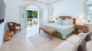 Hemingway House Bedroom with a king bed, sofa, and chair