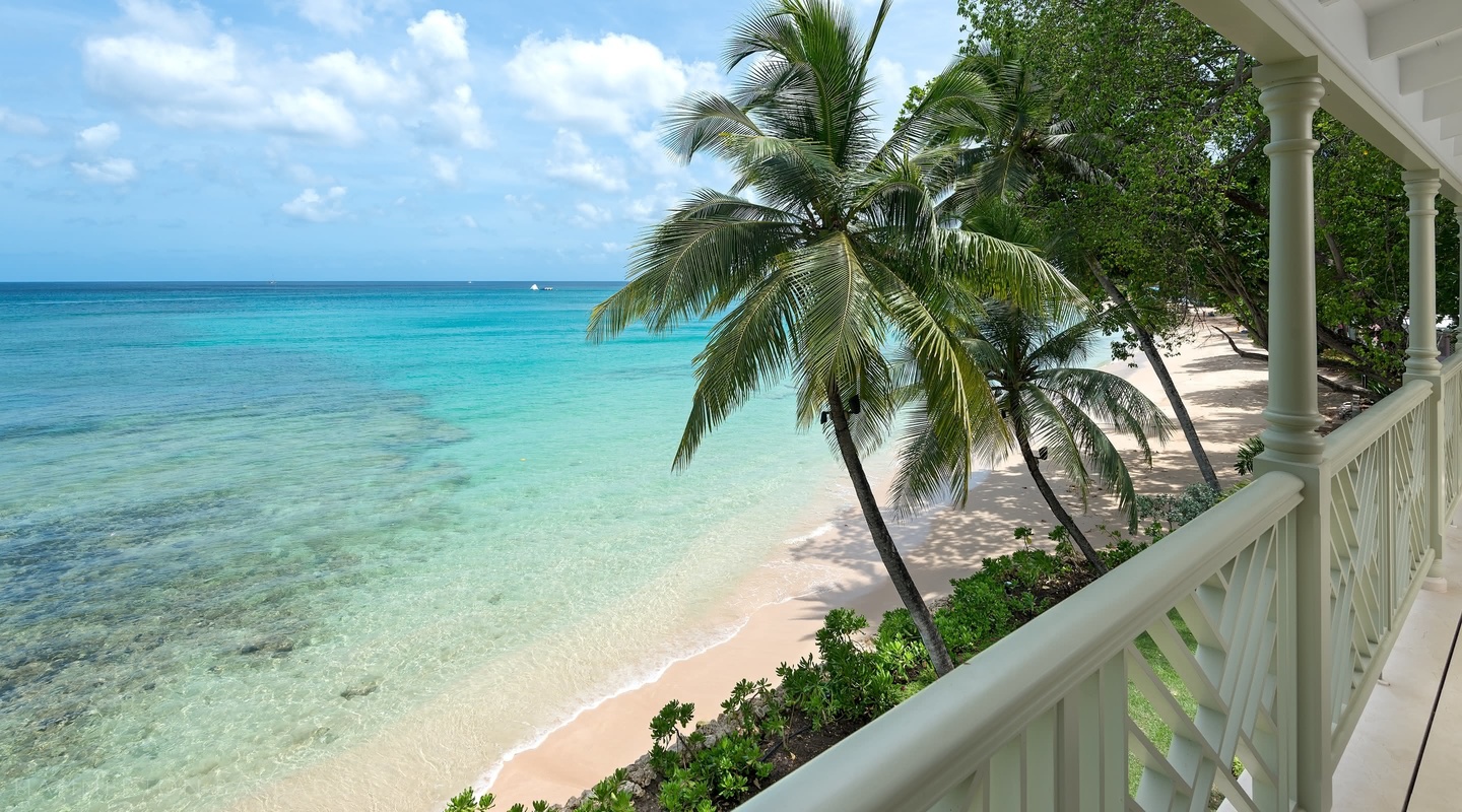 Hemingway House Balcony view of the beach, palm tree and ocean