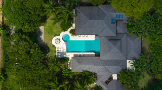 Aerial of the whole villa and pool among mature trees at Jamoon, Sandy Lane Estate, Barbados