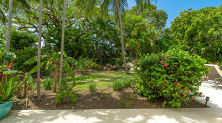 Landscaped garden with hibiscus and palms at Jamoon, fully staffed villa in St. James, Barbados