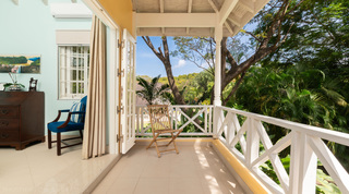Bedroom balcony with X-frame balustrade over the treetops at Jamoon villa in Barbados