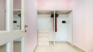 Walk-in dressing room with hanging rail and drawers at Jamoon villa, Barbados