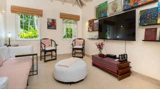 Media room with a large screen and tropical art collection at Jamoon villa, St. James, Barbados