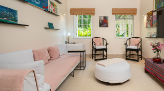 Media room with pink daybed and colourful gallery wall at Jamoon, Barbados