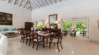 Formal dining room with antique mahogany table opening to the garden at Jamoon villa, Barbados
