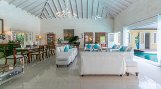 Living room toward the piano and pool-deck doors at Jamoon, holiday villa in St. James, Barbados