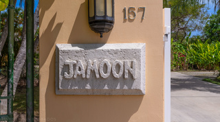 Carved coral-stone Jamoon name plaque and lantern at the gate of this Sandy Lane villa, Barbados