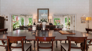 Antique mahogany dining table set with a chess board and mirror at Jamoon, Sandy Lane villas, Barbados