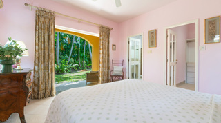 Pink bedroom opening to the garden beside a dressing room at Jamoon, Barbados