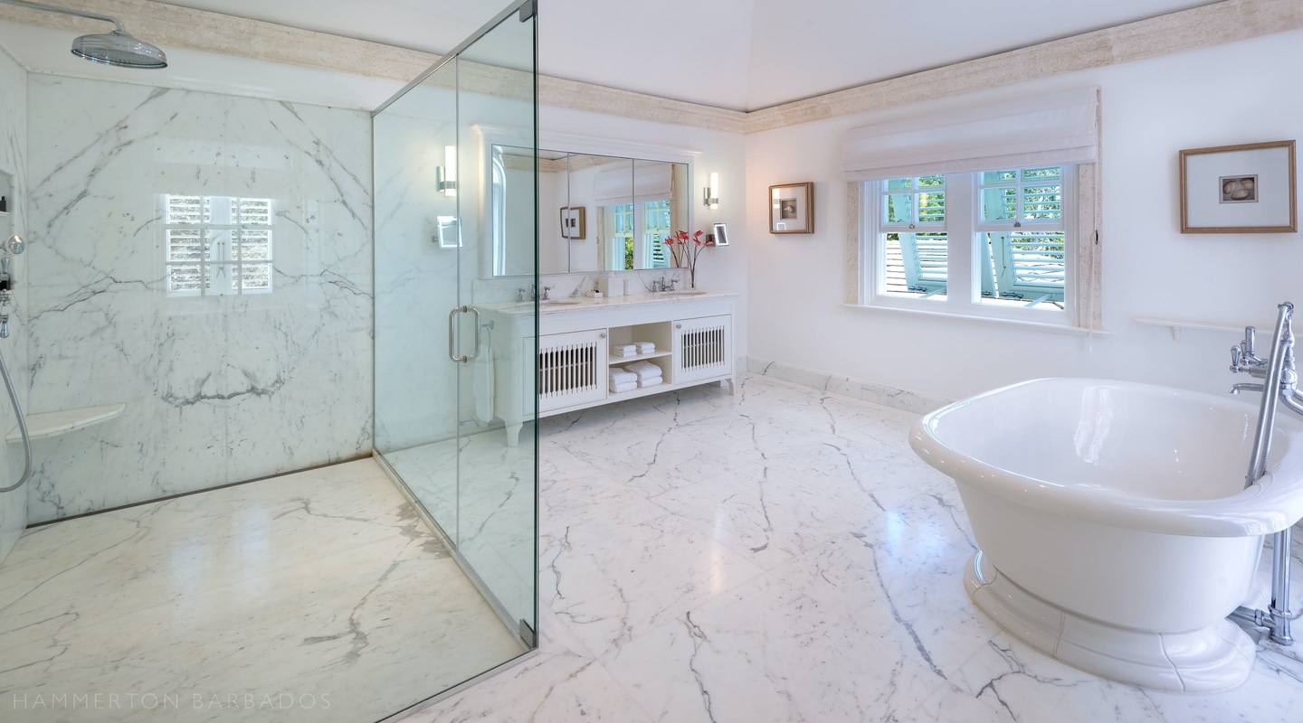 Kiko Villa luxurious modern marble bathroom with large glass shower and roll top bath tub