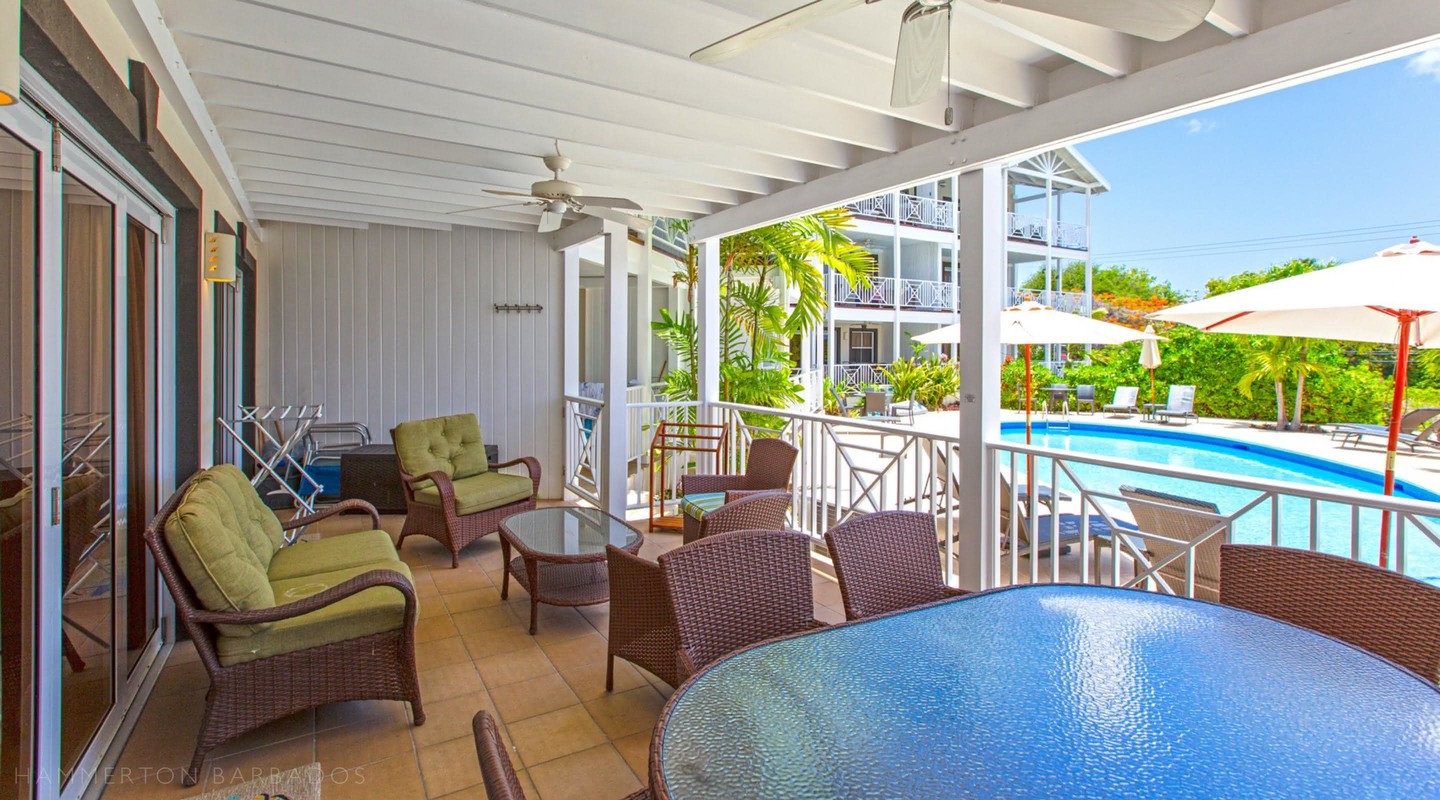 Lantana 2's veranda with seating and swimming pool view