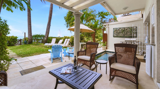 Covered terrace with wicker armchairs and wine at Mahogany Bay – Chanel No.5, Barbados