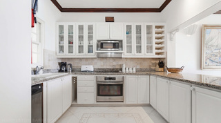 Mahogany Bay – Chanel No.5's fitted kitchen with granite worktops and glass-front cabinets, Barbados
