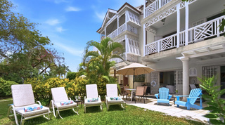 Sun loungers on the lawn beneath Mahogany Bay – Chanel No.5's white fretwork balconies, St. James, Barbados